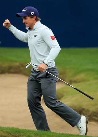 Dunne celebrates after holing out from a bunker on the final hole to close with a 61