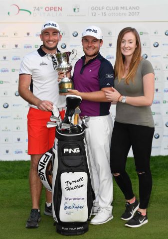 Hatton shows off the trophy with girlfriend Emily and caddy Jonathan Bell