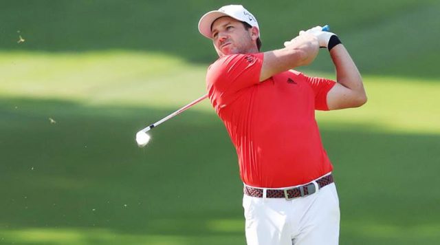 Spain's Sergio Garcia hits a shot on the first hole during the Singapore Open golf tournament at the Sentosa Golf Club in Singapore Sunday, Jan. 21, 2018. Garcia shot a final round of 3-under 68 to finish at 14-under 270 and capture his 33rd professional title. (Kyodo News via AP)