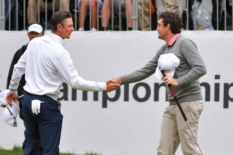 Justin Rose shakes hands with Keegan Bradley after Bradley won the BMW Championship on the first playoff hole at Aronimink Golf Club