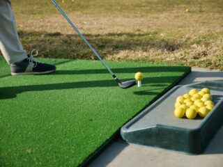 A golfer practising at the driving range