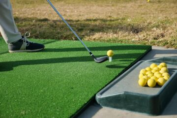 A golfer practising at the driving range
