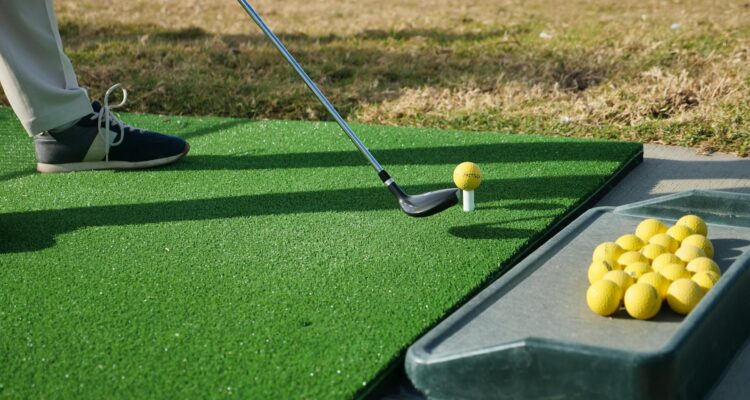 A golfer practising at the driving range